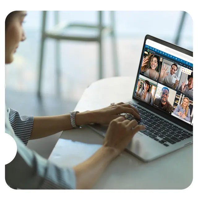 A person on a video call with their team on a laptop